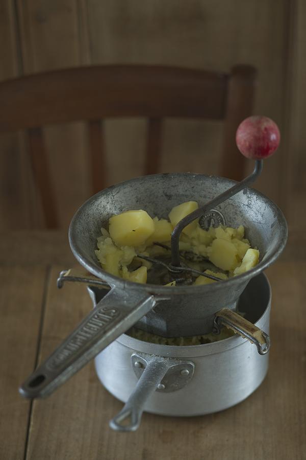Mashing Potatoes With A Vegetable Masher Photograph by Cabanes-valle