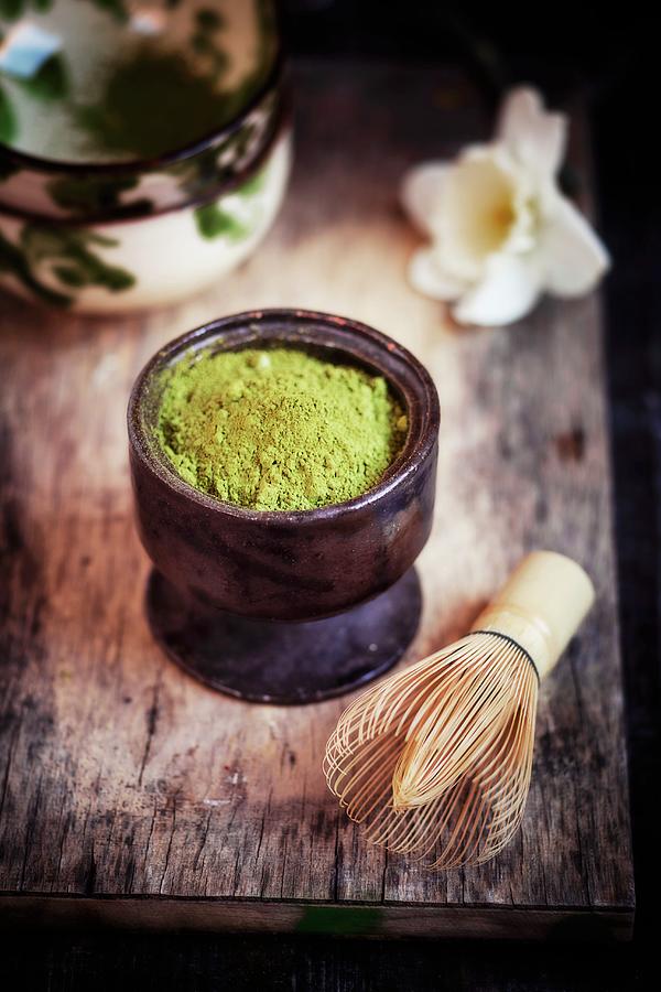 Matcha Tea Powder In A Ceramic Pot With Tea Bowls And A Bamboo Whisk Photograph by Susan Brooks-dammann