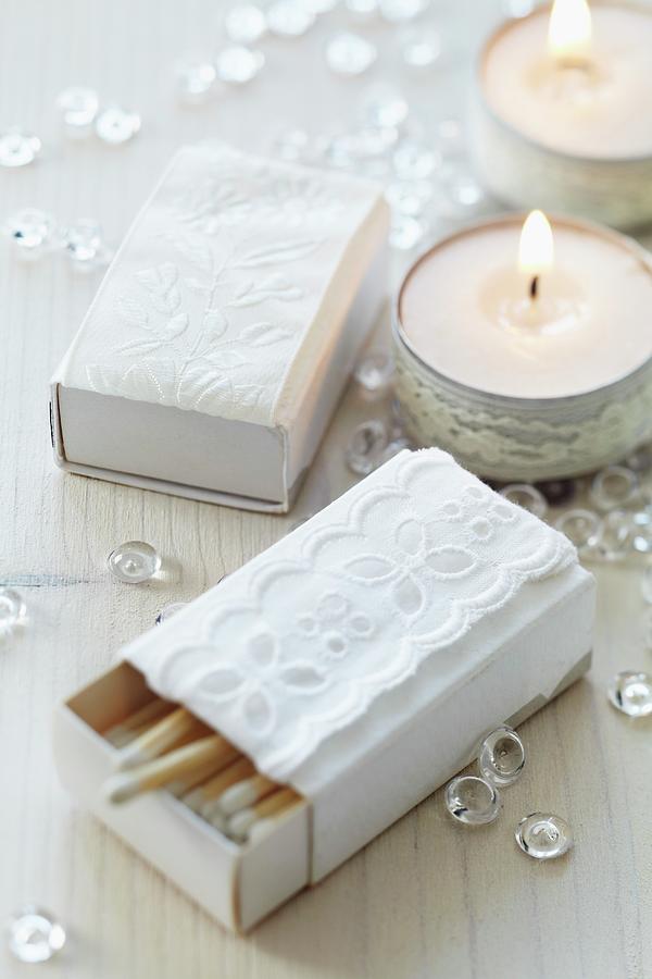 Matchboxes Covered In White Paper And Decorated With Lace Trim And Decorated Tealights Photograph by Franziska Taube