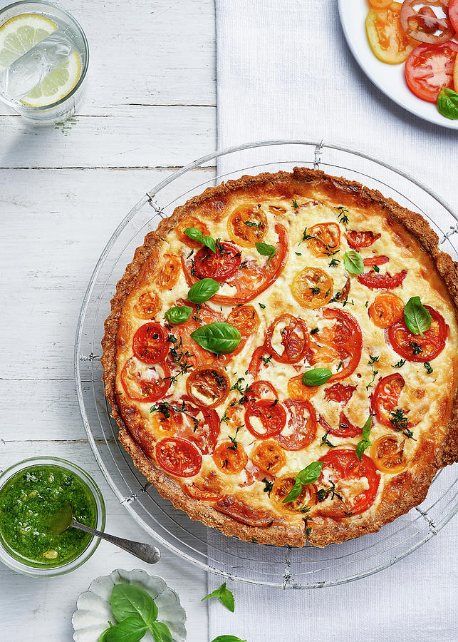 Mature Cheddar And Mixed Heritage Tomato Tart With Wholemeal Crust Served With Pesto And Topped With Fresh Basil Leaves Photograph by Cliqq Photography