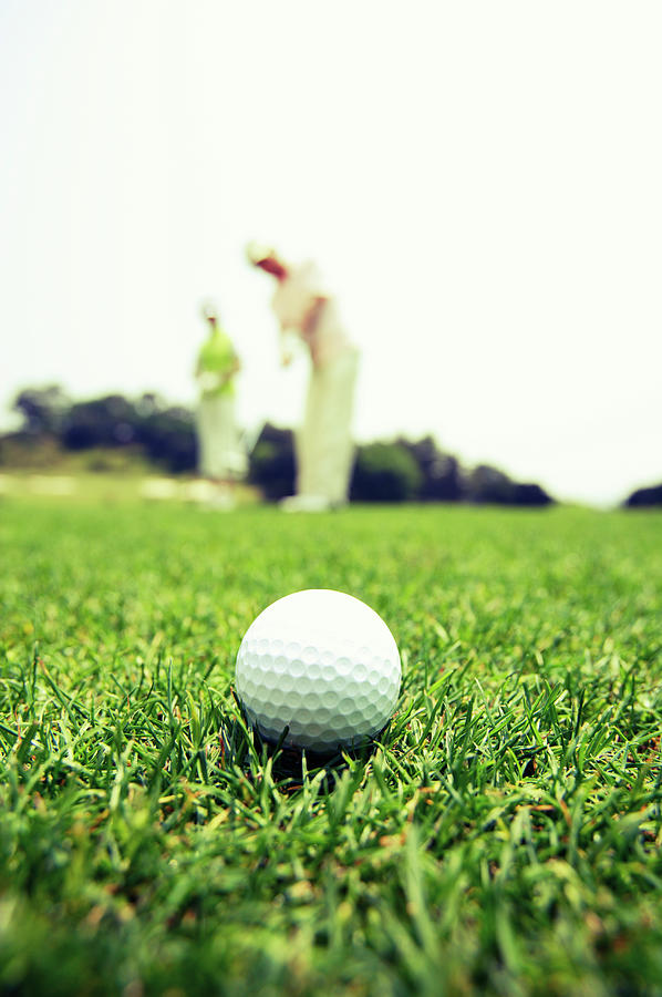 Mature Couple Playing Golf Photograph by Bloom Image