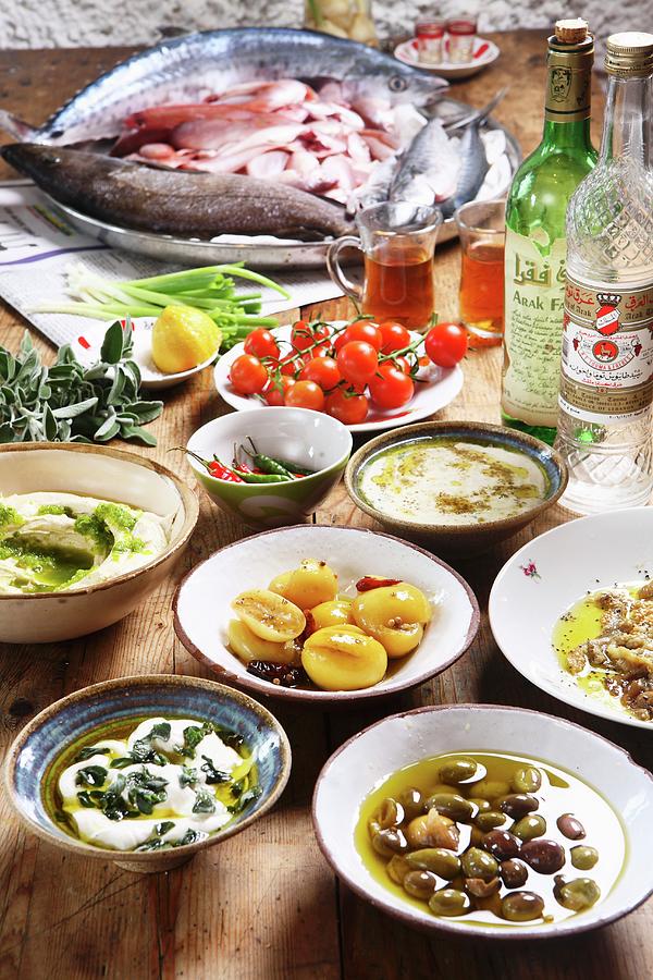 Mazet  Middle Eastern Breakfast Featuring Olives, Salted Lemons, Hummus, Tahini, Aubergine, Red Mullet And Arak Photograph by Kfir Harbi
