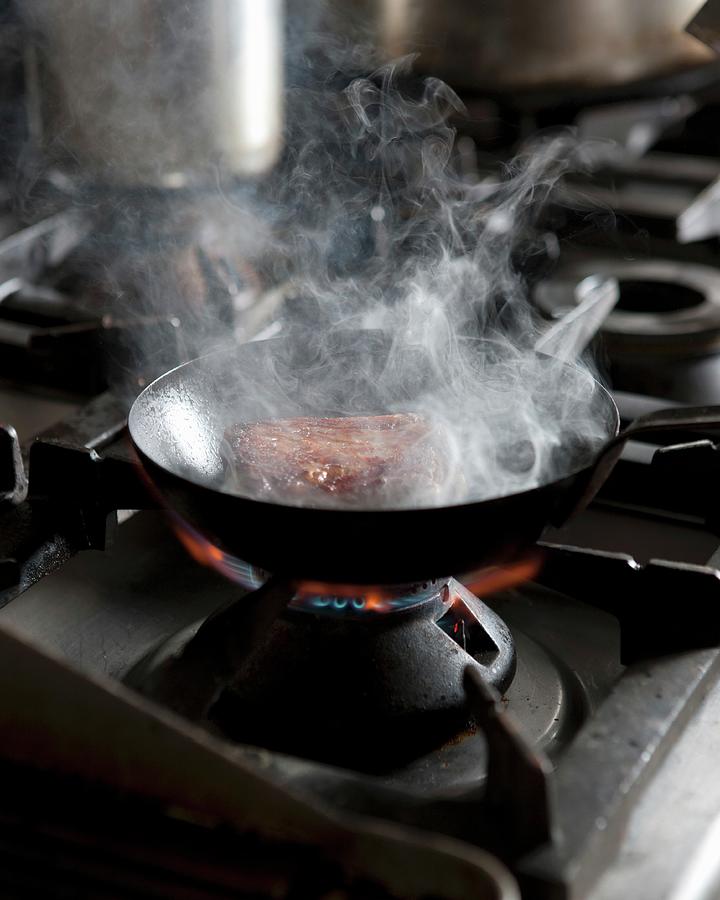 Meat In A Pan On A Gas Stove Photograph by Great Stock!