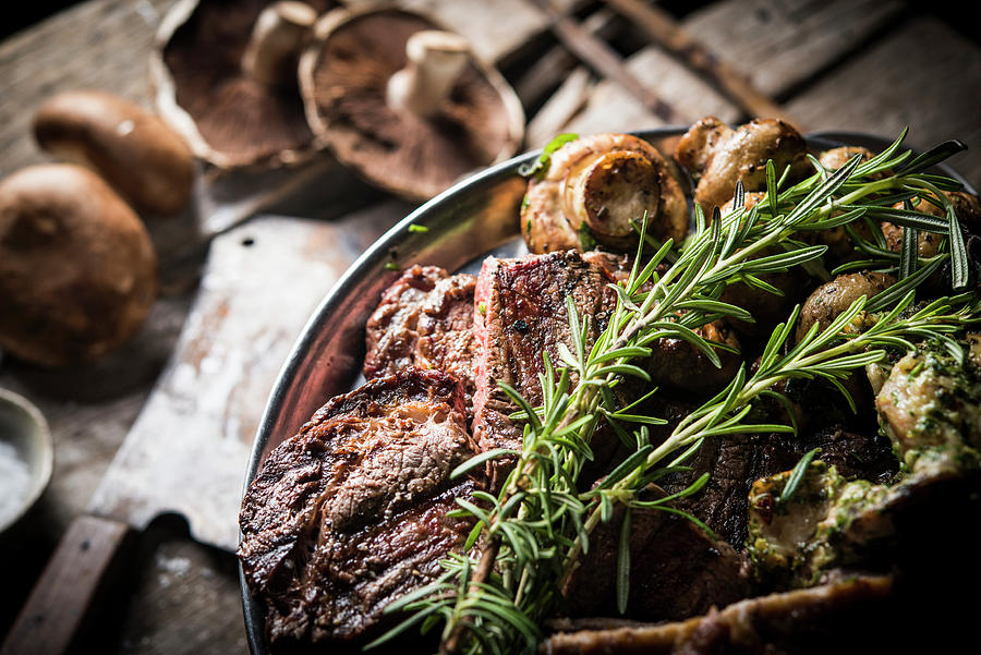 Meat With Mushrooms And Rosemary Photograph by Ben Yuster