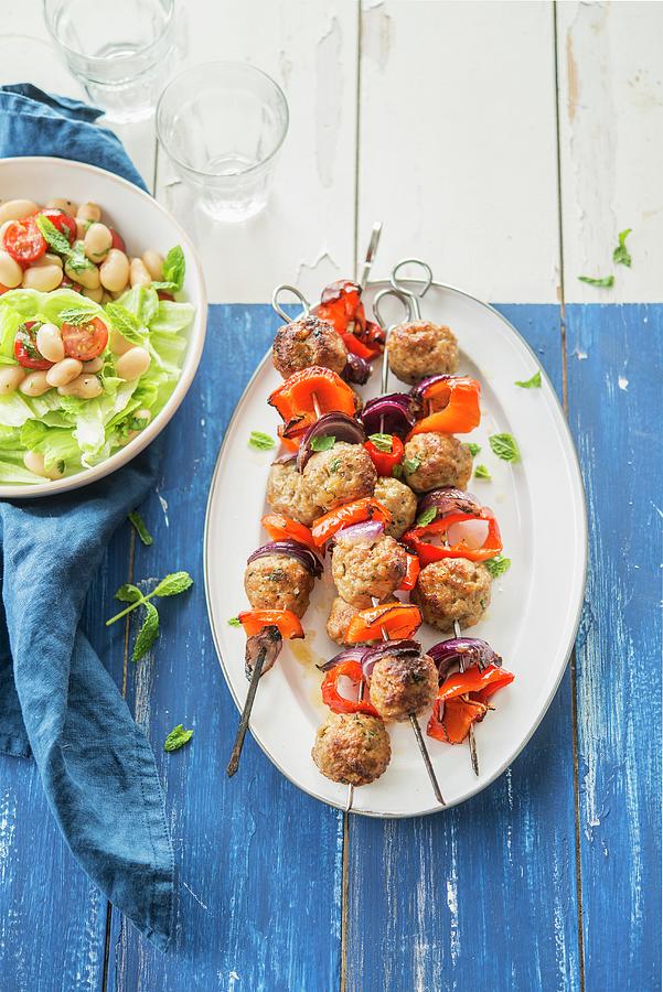 Meatball, Onion And Pepper Skewers, White Haricot Bean And Tomato Salad Photograph by Thys