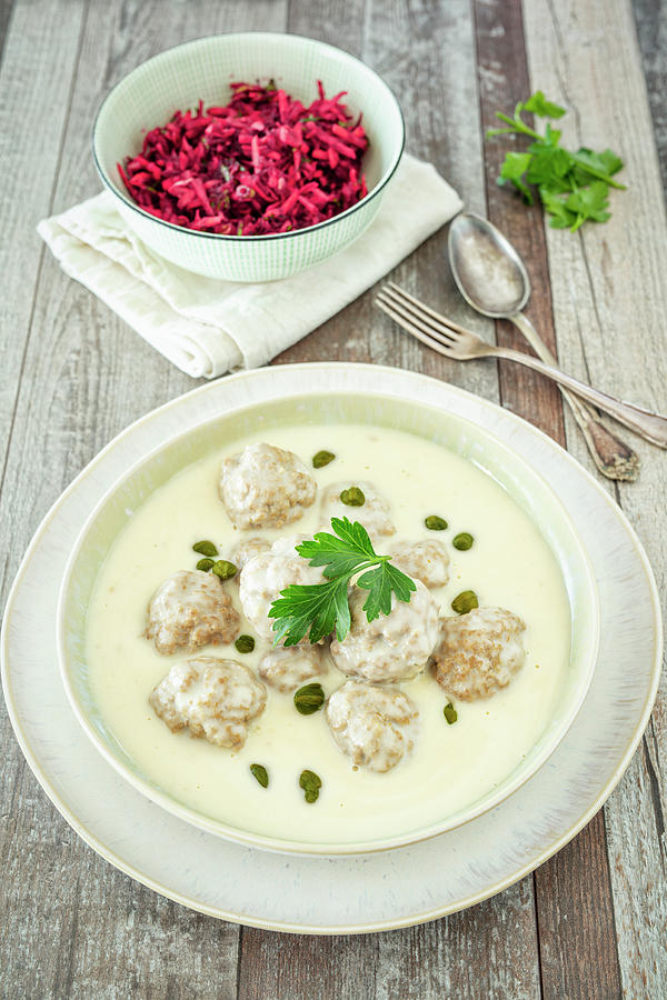 Meatballs In A White Sauce With Capers Served With A Beetroot And Apple Salad Photograph by Jan Wischnewski