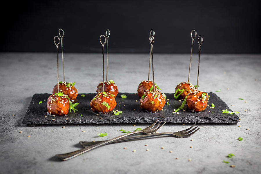 Meatballs With A Hoisin Glaze And Sesame Seeds On Skewers Photograph by Emily Clifton