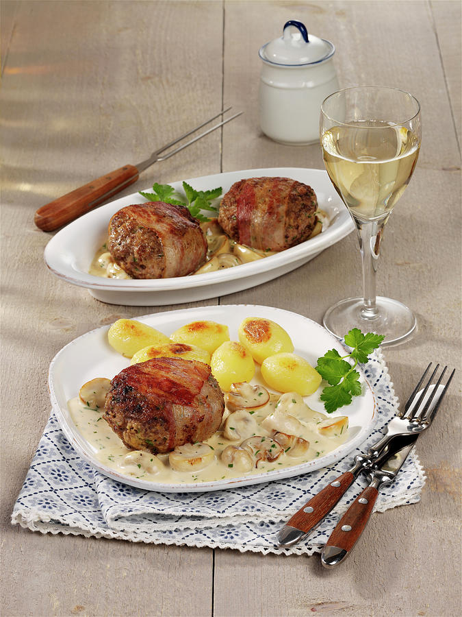 Meatballs Wrapped In Bacon With Creamy Mushrooms And Roast Potatoes Photograph by Photoart / Stockfood Studios