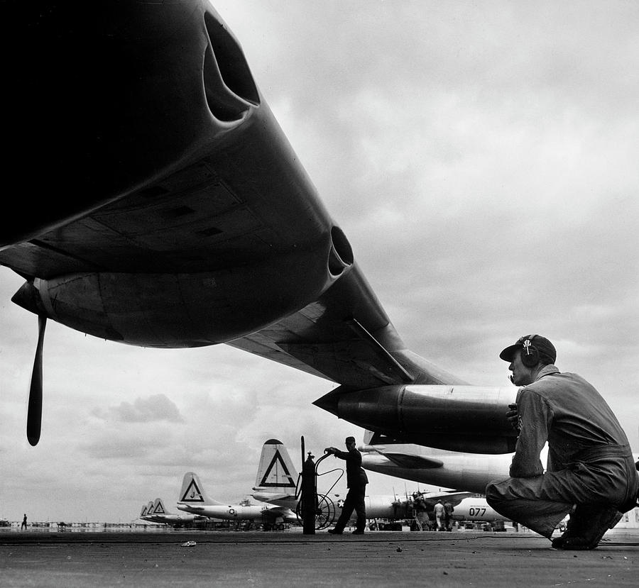 Transportation Photograph - Mechanic Inspecting Bomber Plane by Margaret Bourke-White
