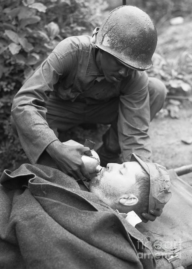 Medic Lowers Canteen To Lips Of Soldier Photograph by Bettmann