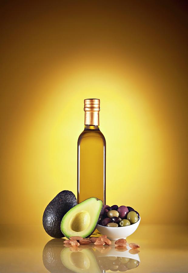 Mediterranean Ingredients; Oil, Avocado, Olives And Almonds Photograph by Richard Fleischman