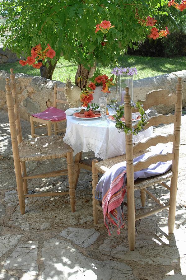 Mediterranean-style Set Table And Wooden Chairs On Terrace Photograph by Twins