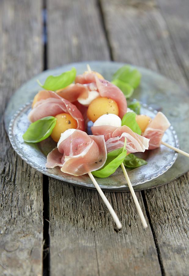 Melon And Mozzarella Skewers With Raw Ham And Basil Photograph by Jo Kirchherr