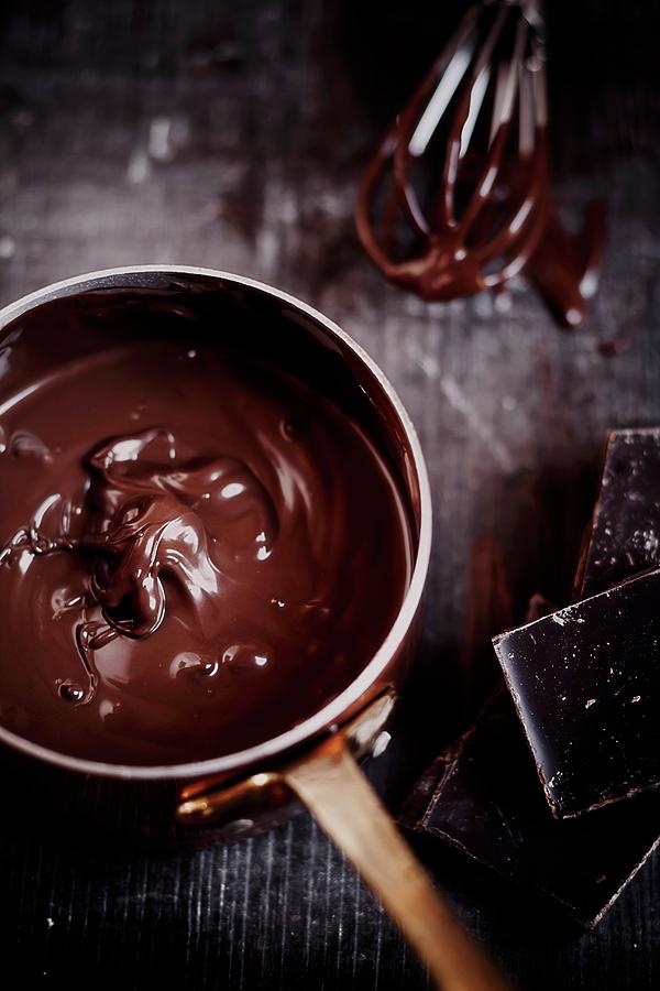 Melted Chocolate In A Copper Pan With Pieces Of Chocolate Next To It Photograph by Susan Brooks-dammann