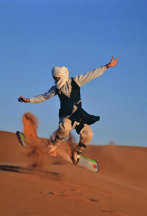 Men, Board Jumping On A Sand Dune Photograph by Friedrich Schmidt