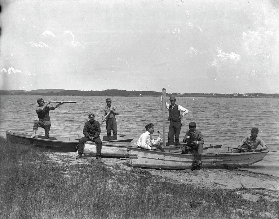 Men In Rowboats On A Narrow Beach By A Photograph by The New York Historical Society