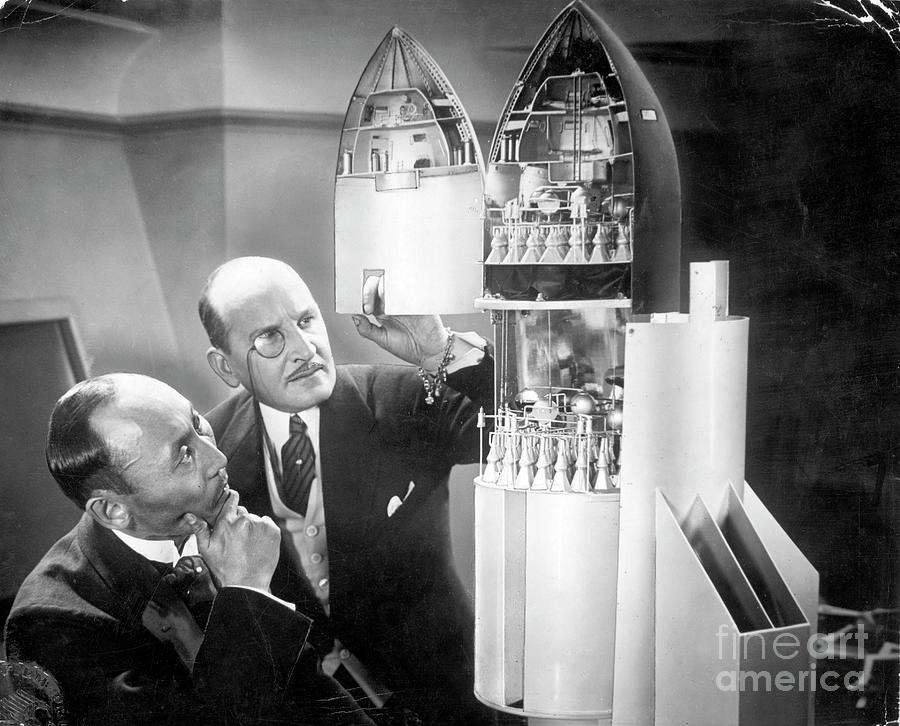 Men Inspecting Rocket Ship Model Photograph by Bettmann