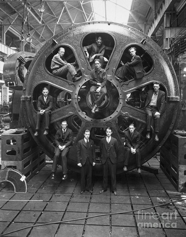 Men Perched Inside Huge Motor Photograph by Bettmann