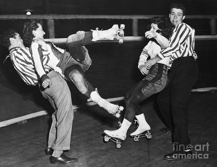 Men Restraining Women Roller Skaters Photograph by Bettmann