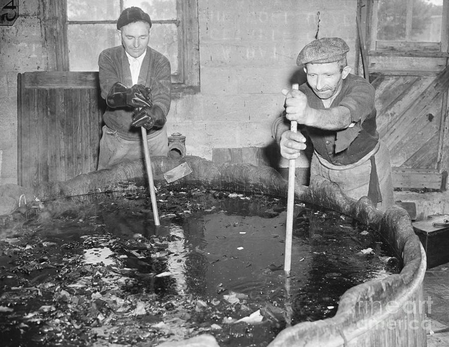 Men Stirring A Pot Of Sulphuric Acid Photograph by Bettmann