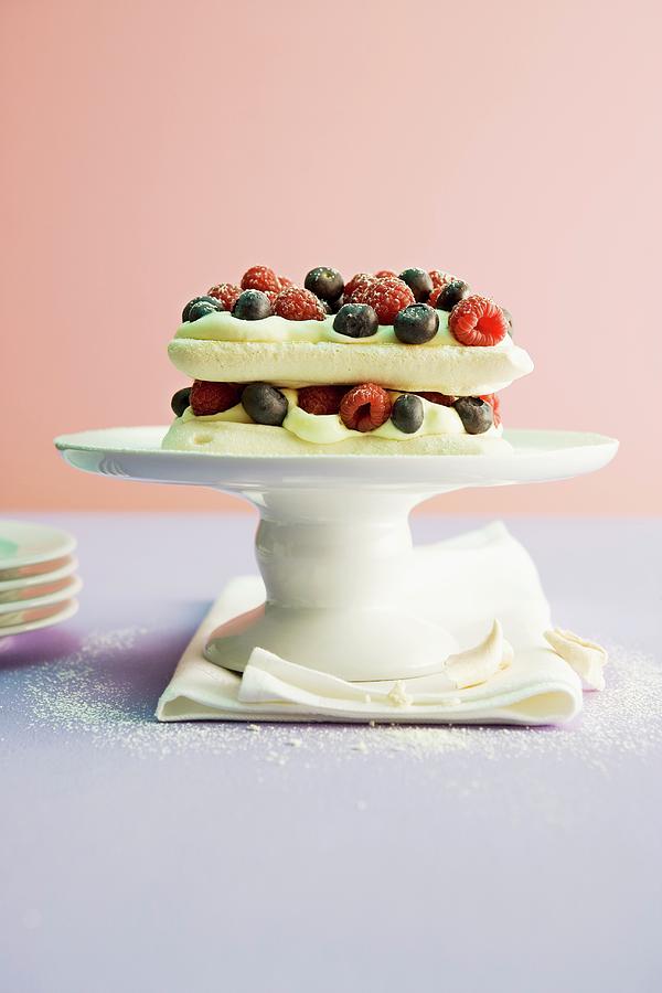 Meringue Cake With Passion Fruit Mousse And Berries Photograph by Michael Wissing