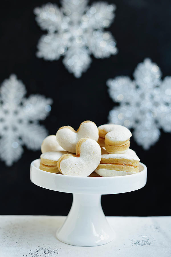 Meringue Cookies Filled With Jam On A Cake Stand Photograph by Brigitte Sporrer