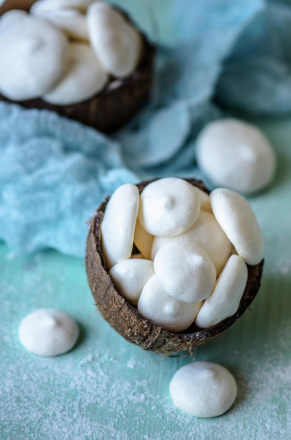 Meringue From Aquafabs In A Coconut Shell On A Blue Background Photograph by Gorobina