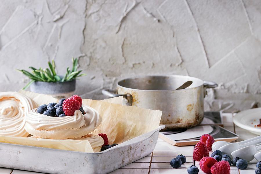 Meringue Nests With Berries For Pavlova On A Kitchen Table Photograph by Natasha Breen