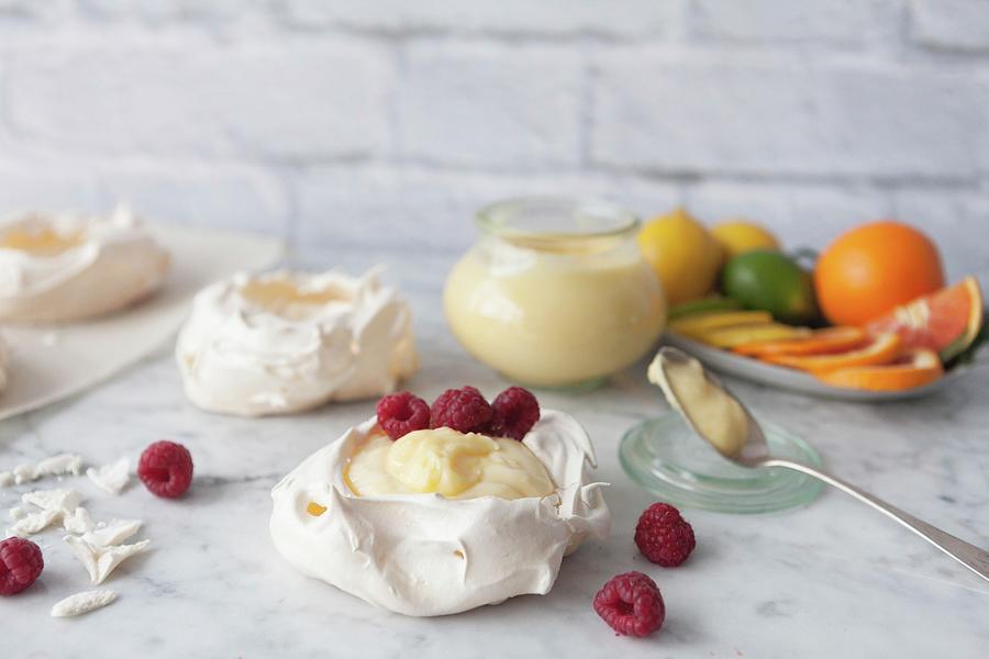 Meringue Nests With Lemon Curd And Raspberries Photograph by Debra Cowie