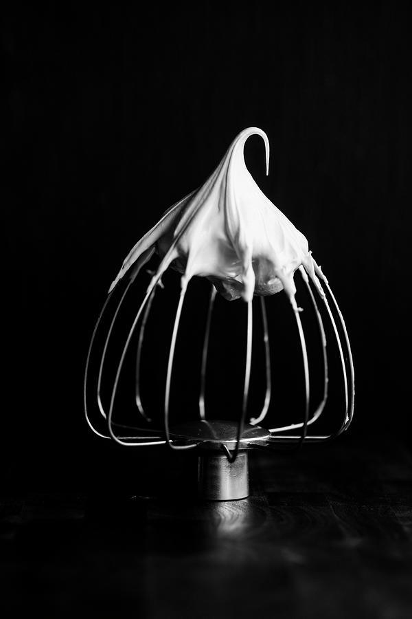 Meringue On A Whisk On A Black Surface Photograph by Katrin Winner