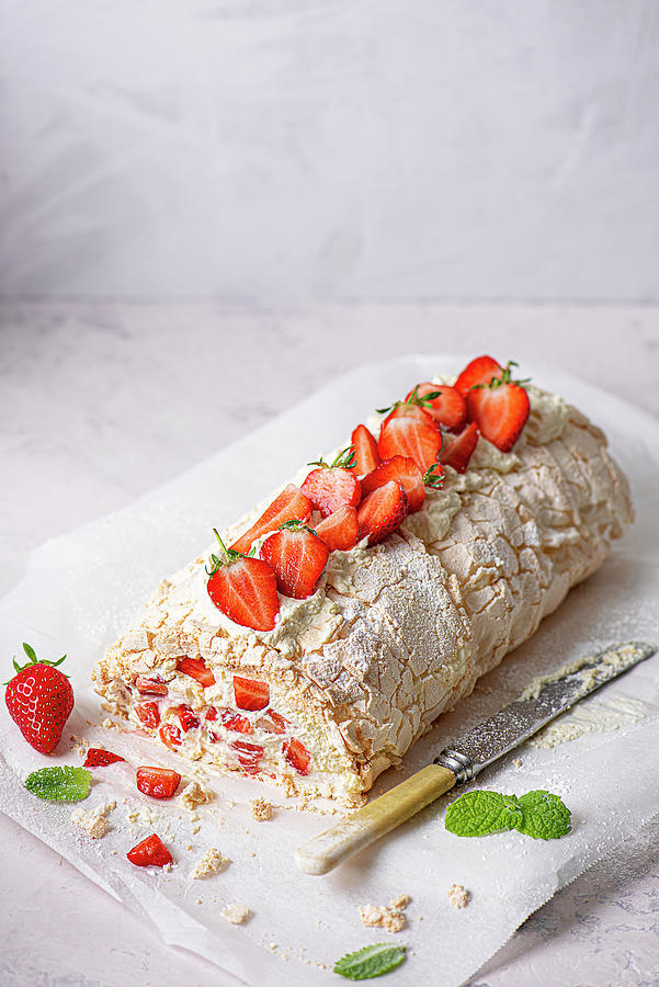 Meringue Roulade With Fresh Whipped Cream And Strawberries Photograph by Magdalena Hendey