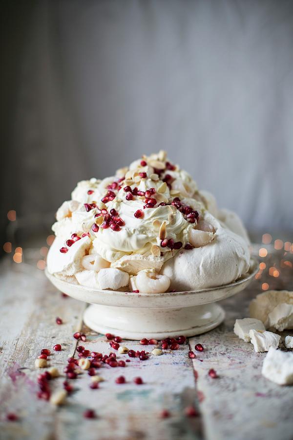 Meringue With Cream, Lychees, Pomegranate And Slivered Almonds Photograph by Helen Cathcart