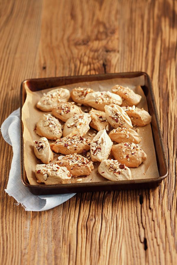 Meringues With Cinnamon And Nuts On A Baking Tray Photograph by Rua Castilho