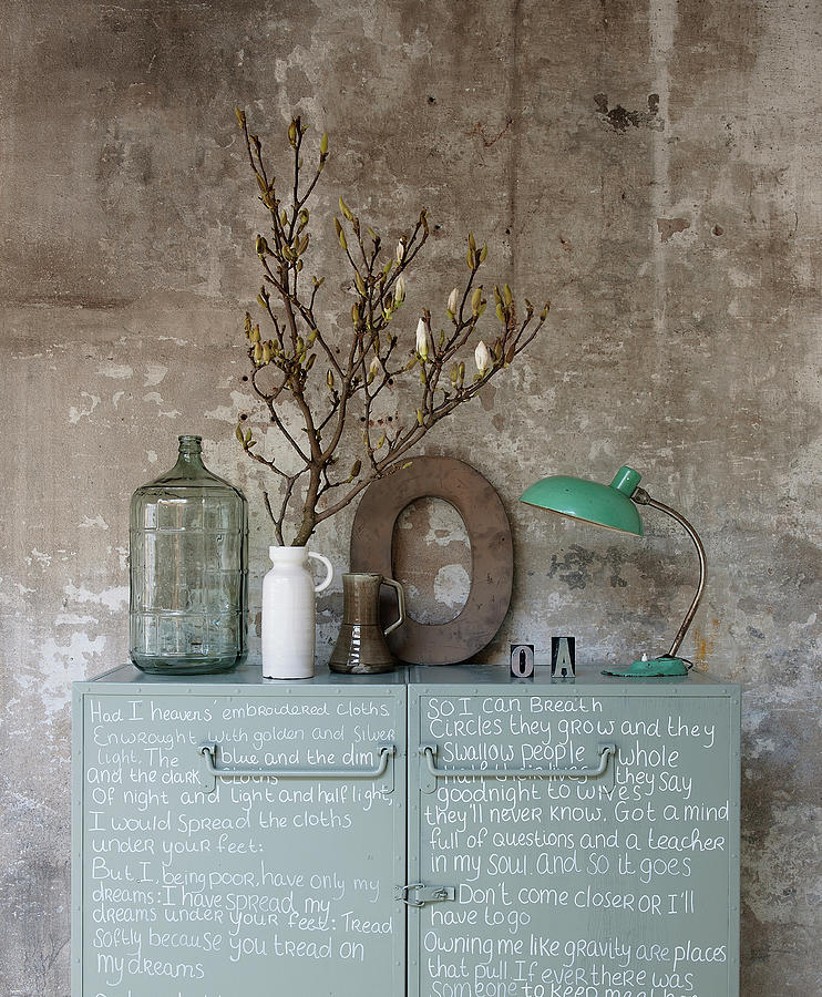 Metal Cabinet Decorated With Handwriting, Vase Of Twigs, Decorative Letter And Table Lamp Photograph by James Stokes