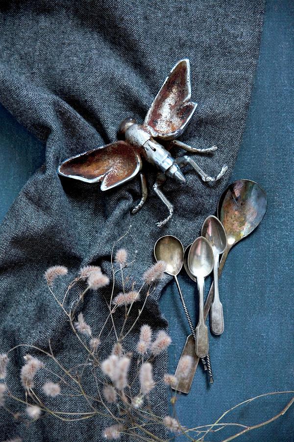 Metal Insect Figurine And Vintage Silver Spoons On Dark Fabric Photograph by Alicja Koll
