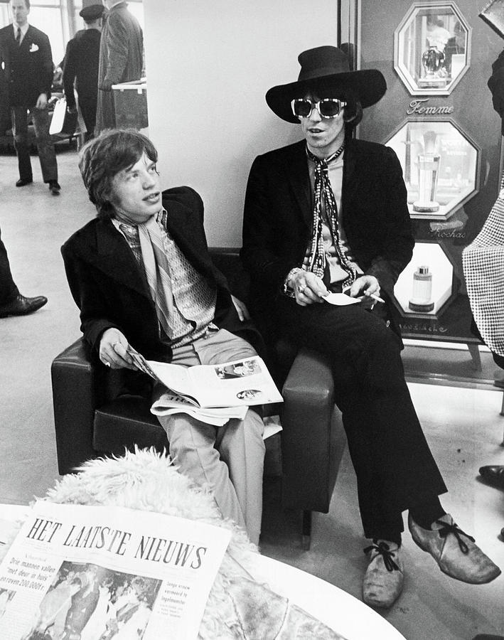 Keith Richards Photograph - Mick Jagger And Keith Richards Candid With Newspaper by Globe Photos