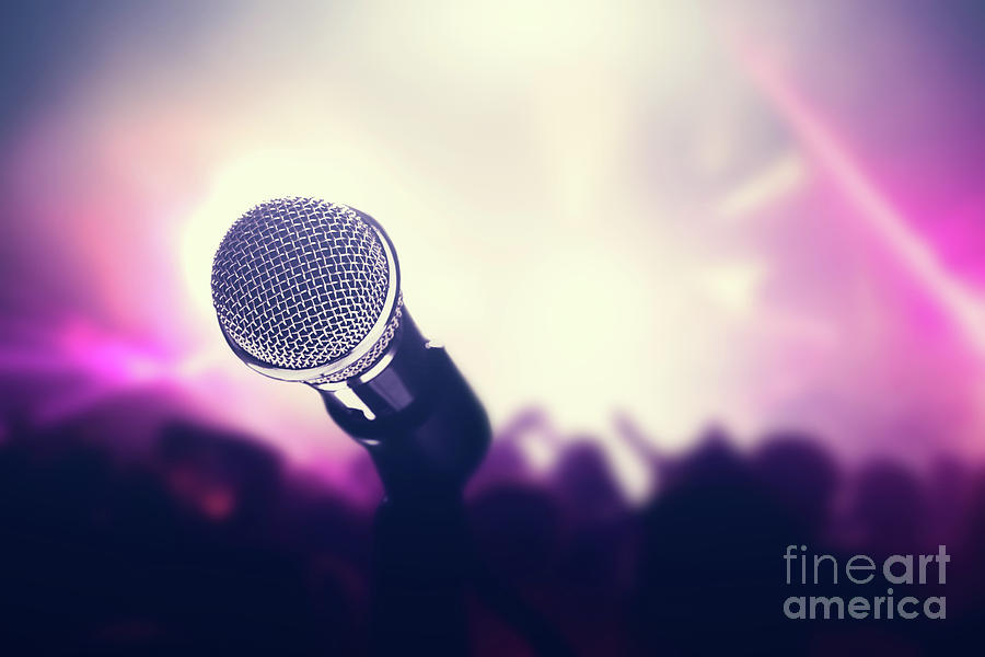 Microphone on stage, crowd of people in the club. Photograph by Michal Bednarek