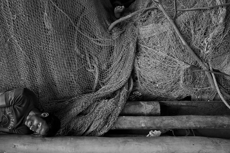 Midday Nap Of A Fisherman At The Fish Dock Photograph by Fahad Bin Solaiman