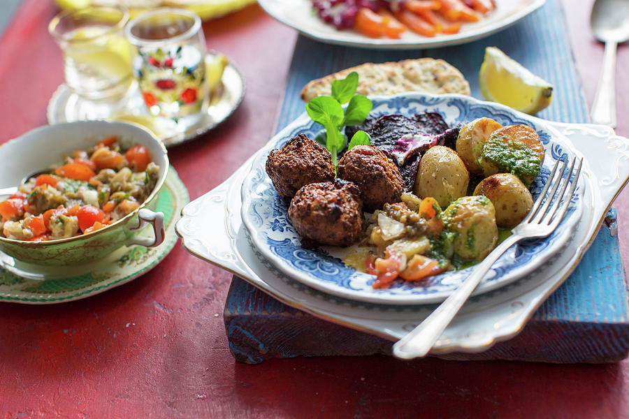 Middle Easterrn Supper With Chickpea Falafel, Mutabal Dip, Roast Potatoes And Beetroot Crips Photograph by Lara Jane Thorpe