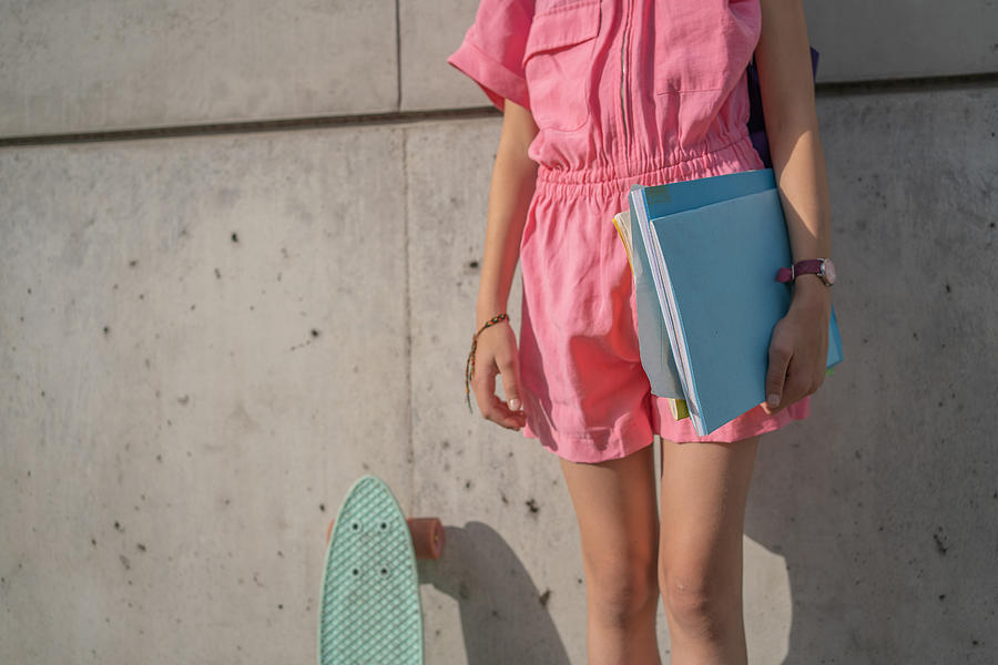 Summer Photograph - Midsection Of Teenage Girl With Skateboard And Hotebooks by Cavan Images