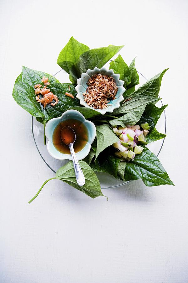 Mieng Kham an Appetiser Featuring Prawns, Coconut, Lime And Dip Served On Pepper Leaves, Thailand Photograph by Michael Wissing