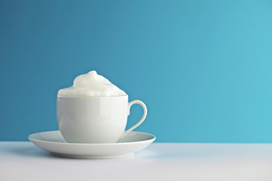 Milk Froth In A Cup Photograph by Herbert Lehmann