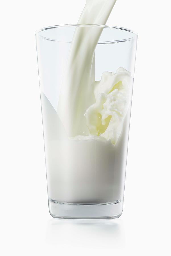 Milk Pouring Into Glass Photograph by Jack Andersen
