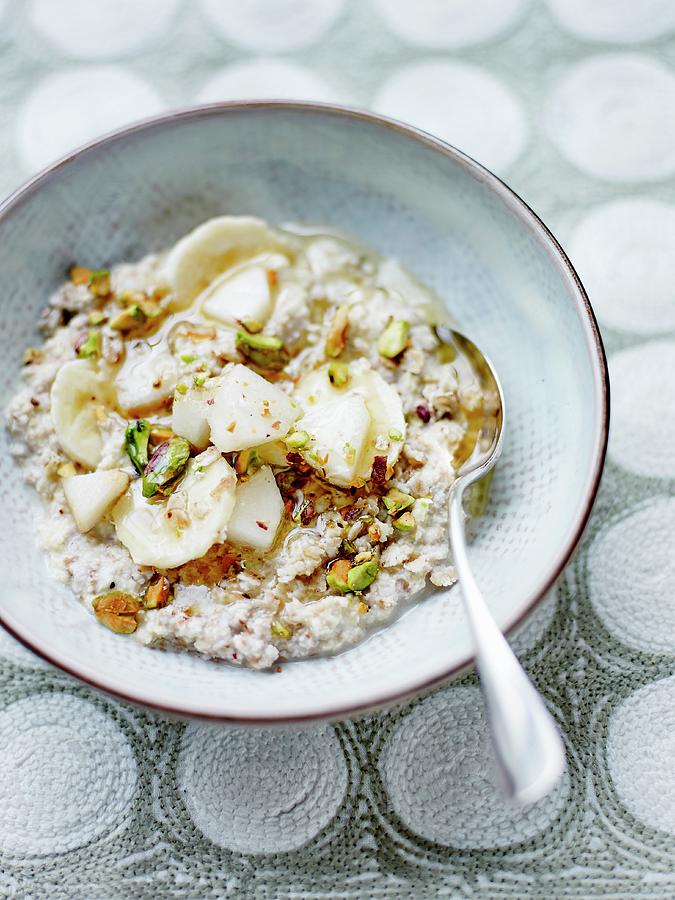 Millet And Buckwheat Porridge With Rice Milk, Pear, Banana And Crushed Pistachios Photograph by Amiel