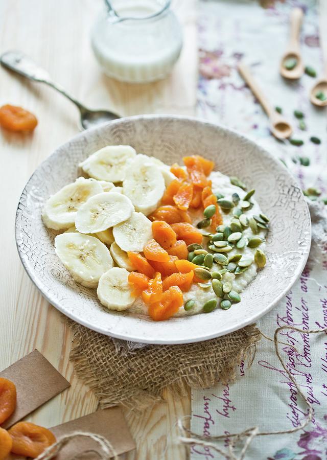 Millet Flakes Of Almond Milk, Bananas, Dried Apricots And Pumpkin Seeds Photograph by Dorota Indycka
