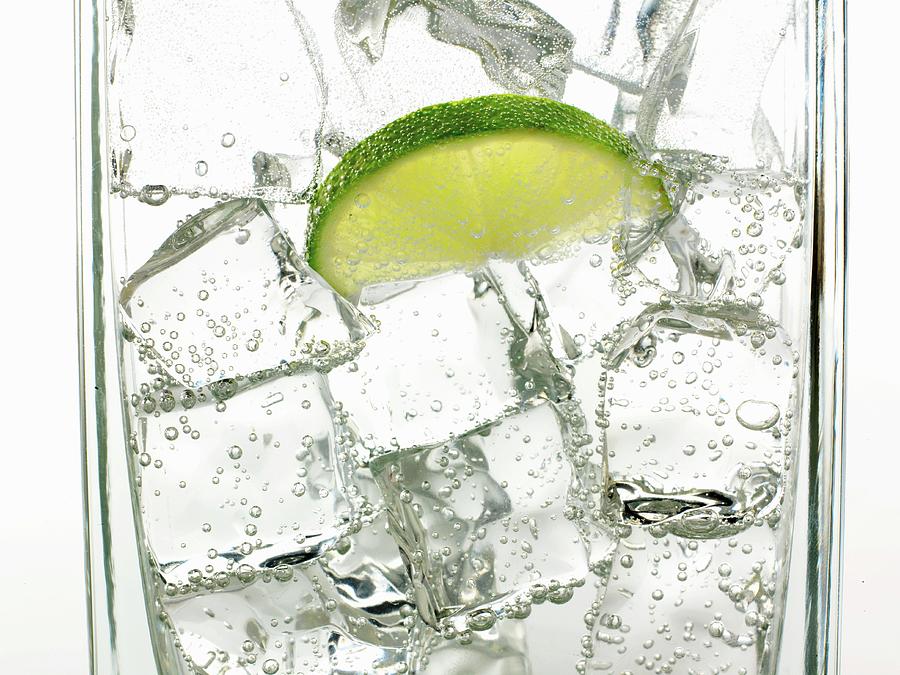 Mineral Water With Ice Cubes And A Slice Of Lime Photograph by Frank Adam