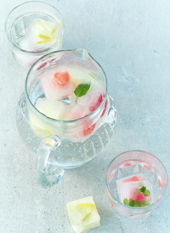 Mineral Water With Summer Fruit Ice Cubes In A Jug Photograph by Stefan Schulte-ladbeck