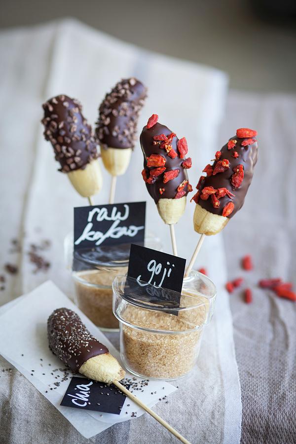 Mini Bananas With A Chocolate Glaze, Raw Cocoa Nibs, Chia Seeds And Goji Berries superfood Photograph by Eising Studio