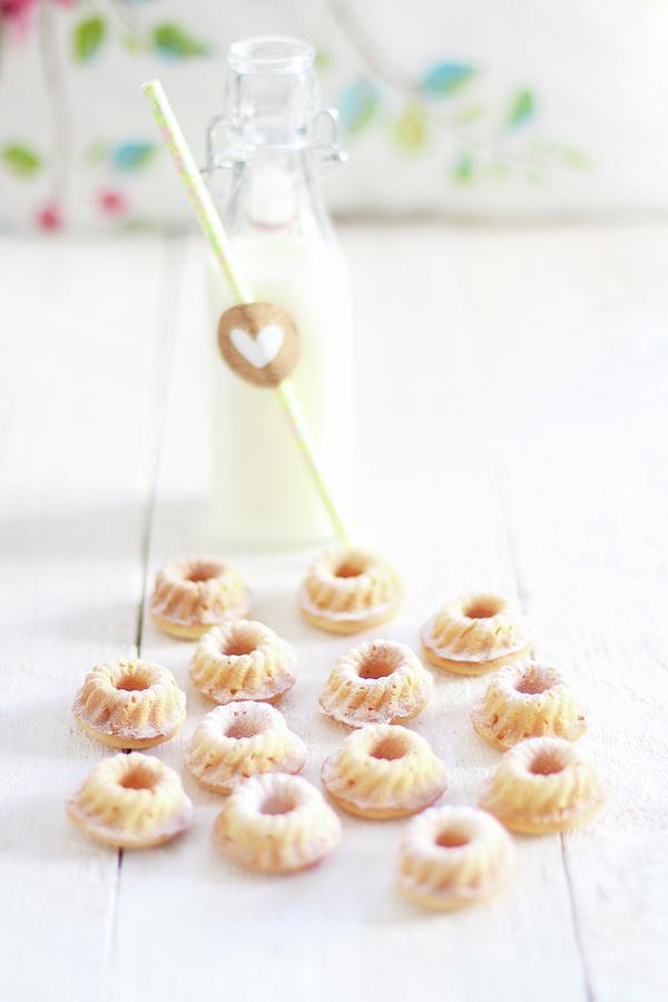 Mini Bundt Cakes And A Bottle Of Milk On A White Wooden Table Photograph by Sylvia E.k Photography