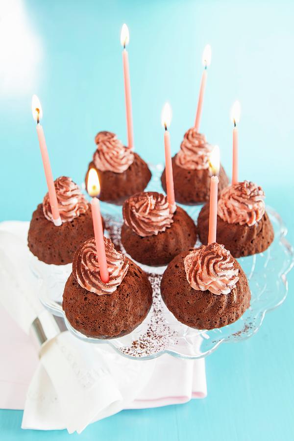 Mini Bundt Cakes Decorated With Birthday Candles Photograph by Anneliese Kompatscher